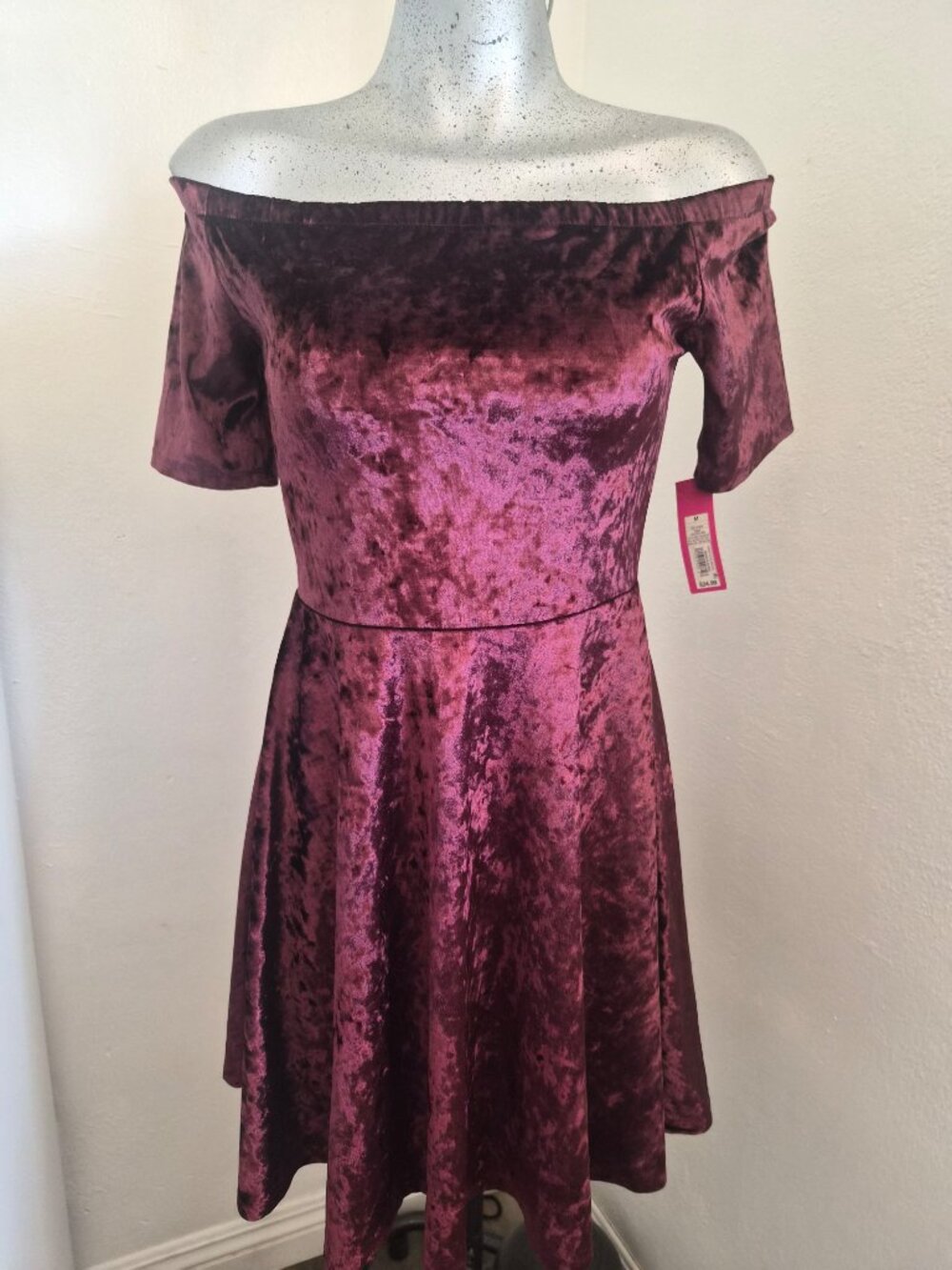 burgundy velvet off-shoulder dress.